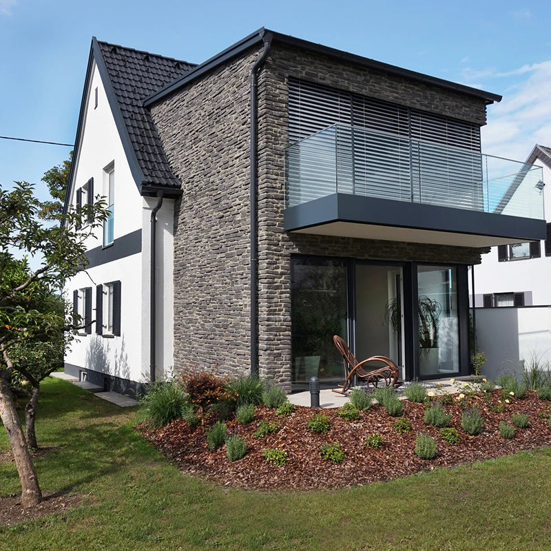 manufactured stone siding sierra anthracite handmade 101220 installed facade ofmodern house glass balcony